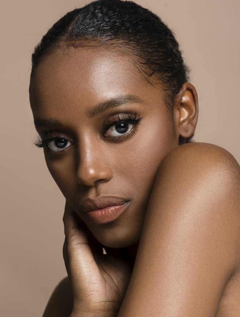 Stunning close-up portrait of a black woman with expressive eyes in a studio setting.